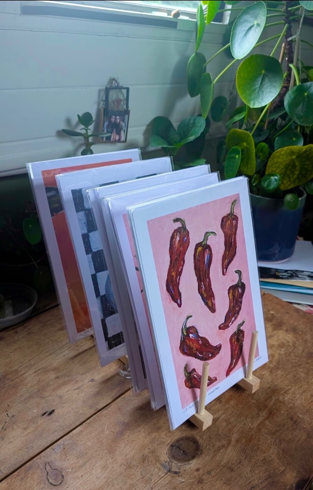 A set of Joio Art prints displayed on a wooden easel